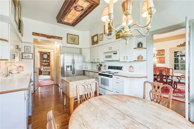 a view of a hallway with wooden floor and furniture