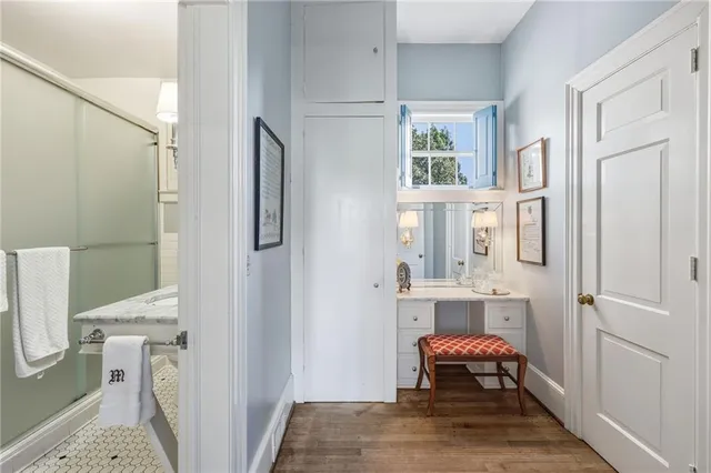 a bedroom with a large bed a flat tv screen and a dresser