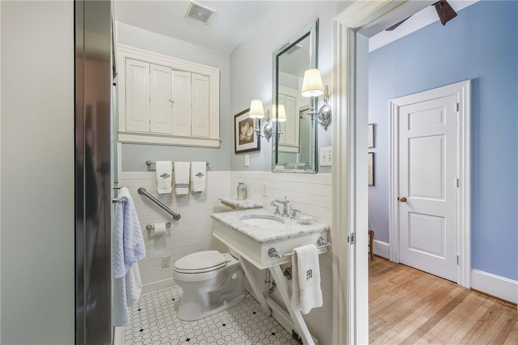 1606 Riverside Drive Gainesville, GA 30501 - Photo 26 of 55 a bathroom with a granite countertop sink a toilet and a mirror