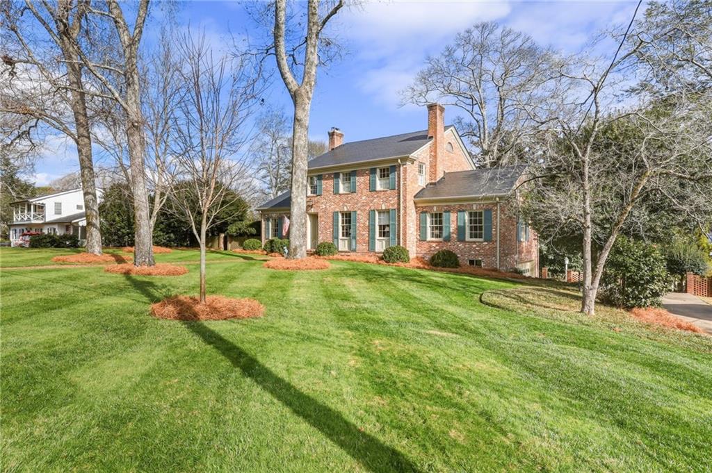 1606 Riverside Drive Gainesville, GA 30501 - Photo 3 of 55 a front view of a house with a yard table and chairs