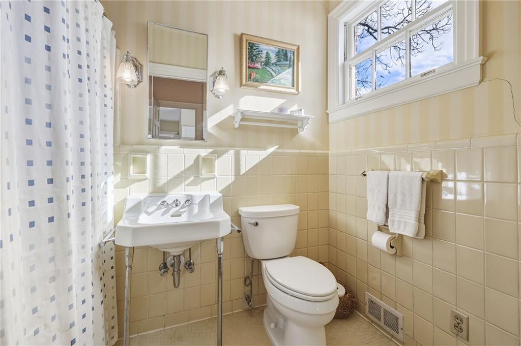 1606 Riverside Drive Gainesville, GA 30501 - Photo 36 of 55 a bathroom with a toilet sink and mirror