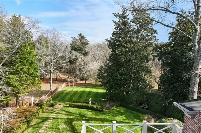 a swimming pool with lots of tress in front of it