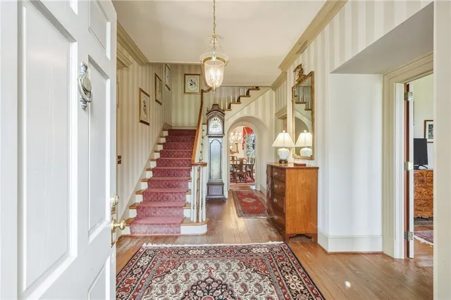 a view of entryway and hall with wooden floor