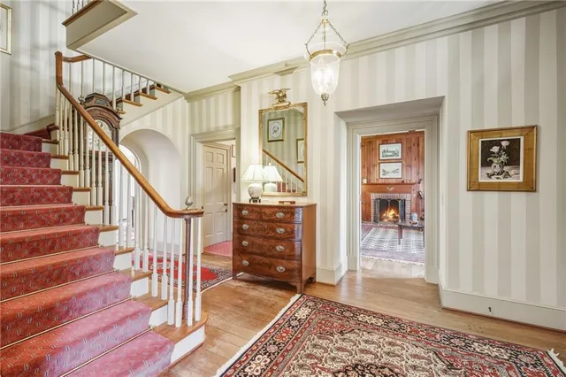 a living room with furniture a rug and a painting on the wall