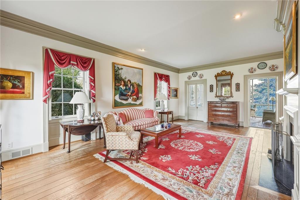 1606 Riverside Drive Gainesville, GA 30501 - Photo 9 of 55 a living room with furniture a rug and a painting on the wall