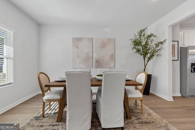 a view of a dining room with furniture and a potted plant