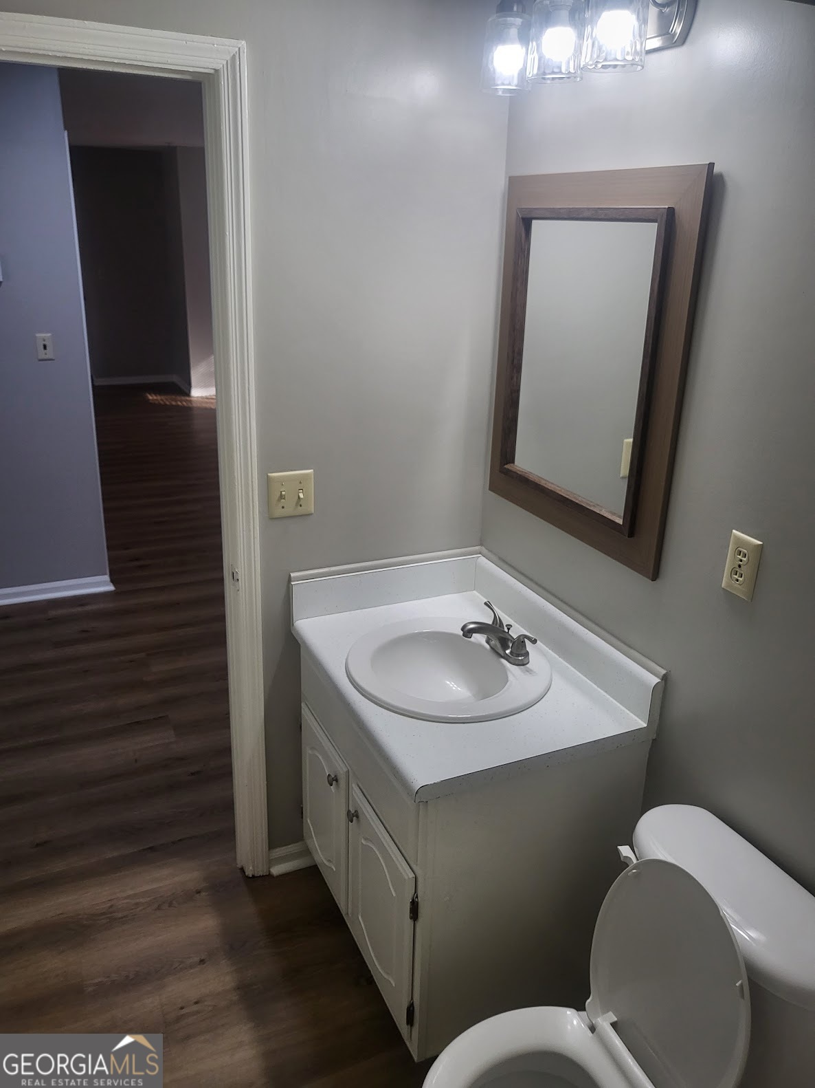 1207 Firestone Drive Albany, GA 31707 - Photo 11 of 15 a bathroom with a toilet a sink and mirror