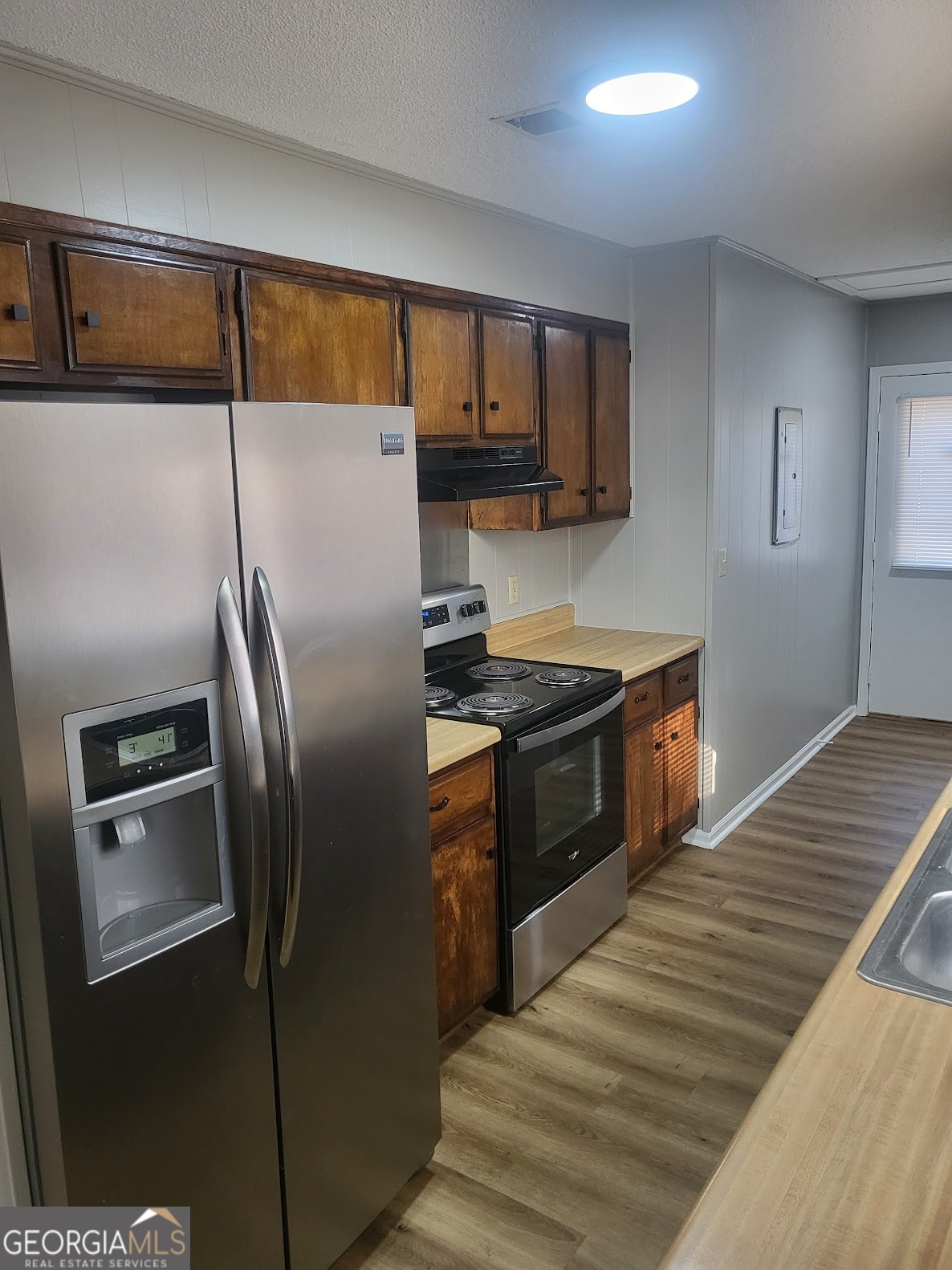 1207 Firestone Drive Albany, GA 31707 - Photo 12 of 15 a kitchen with stainless steel appliances granite countertop a refrigerator a stove and a sink with wooden floor