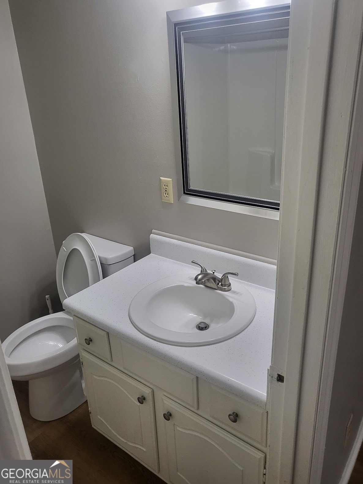 1207 Firestone Drive Albany, GA 31707 - Photo 6 of 15 a bathroom with a toilet sink and mirror