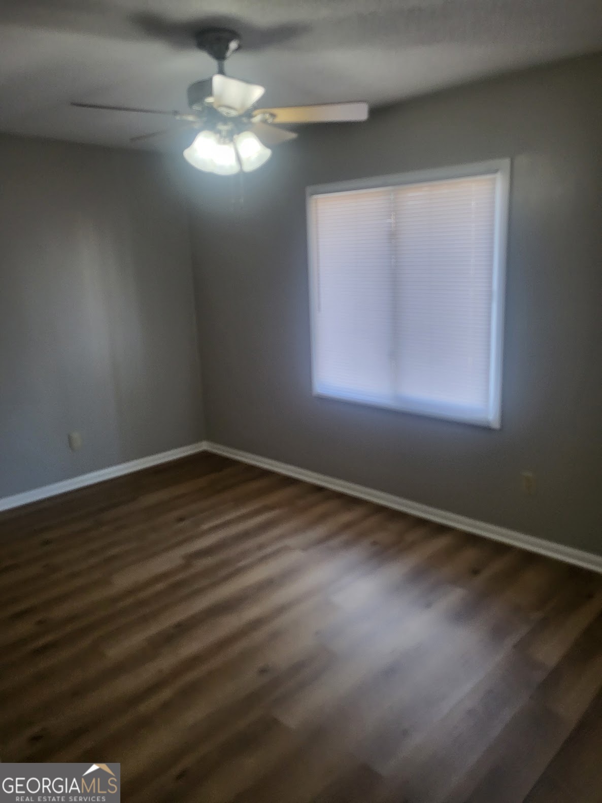 1207 Firestone Drive Albany, GA 31707 - Photo 10 of 15 a view of an empty room with wooden floor and a window