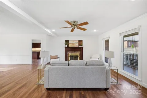 a living room with fireplace furniture and a wooden floor