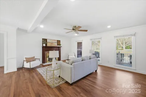 a living room with fireplace furniture and a wooden floor