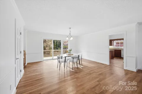 an dining room with furniture window and wooden floor