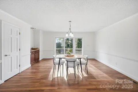 a view of a dining room with furniture wooden floor and a rug