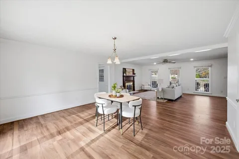 a living room with fireplace furniture and a wooden floor