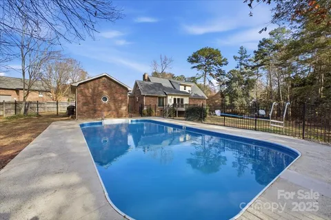 a view of a swimming pool with a house