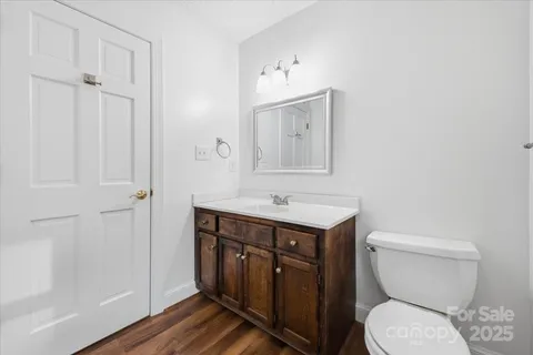 a bathroom with a toilet a sink and mirror