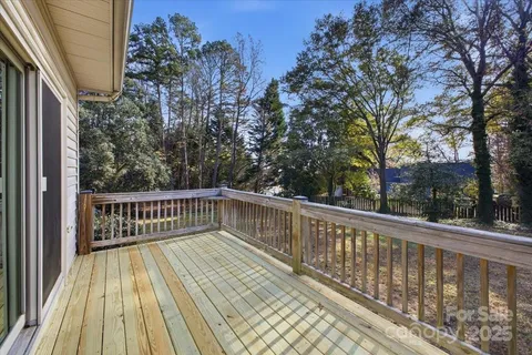 a view of balcony with wooden floor and fence