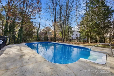 a view of a swimming pool with trees in the background