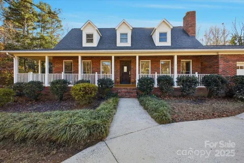 a front view of a house with garden and porch