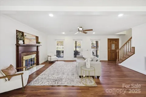 a living room with fireplace furniture and a wooden floor