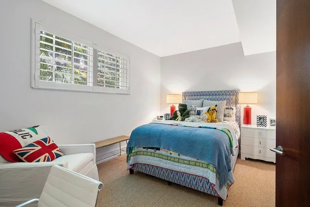 a bedroom with bed and a window