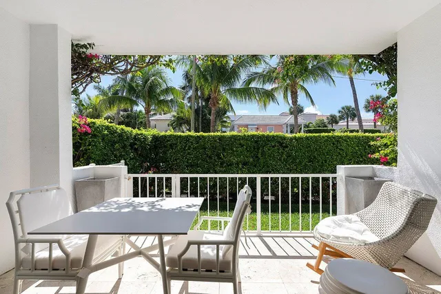a view of a chairs and table in patio