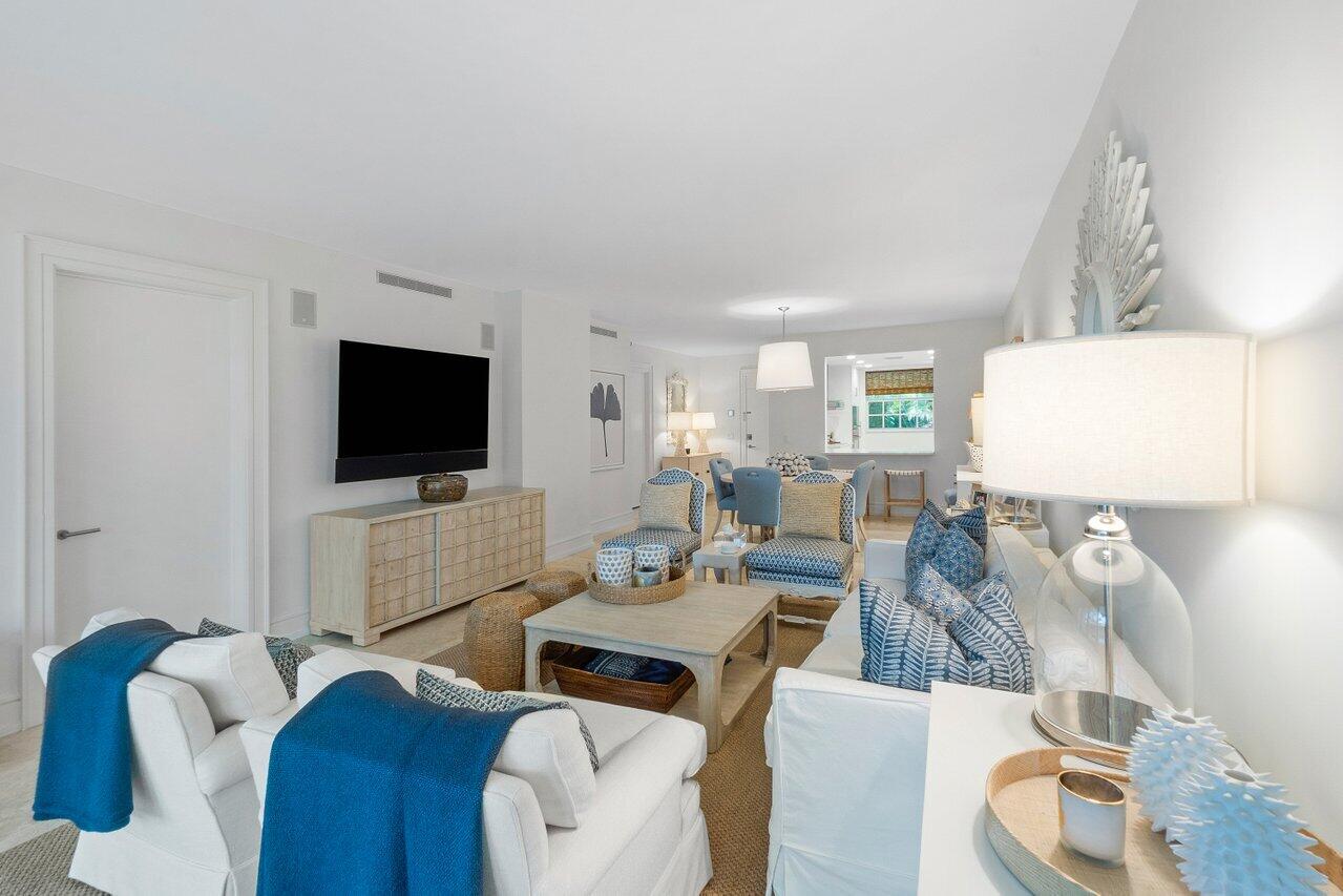 127 Peruvian Avenue, Unit 101 Palm Beach, FL 33480 - Photo 5 of 16 a living room with furniture a flat screen tv and kitchen view