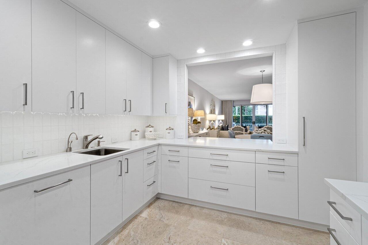 127 Peruvian Avenue, Unit 101 Palm Beach, FL 33480 - Photo 9 of 16 a kitchen with a sink and cabinets