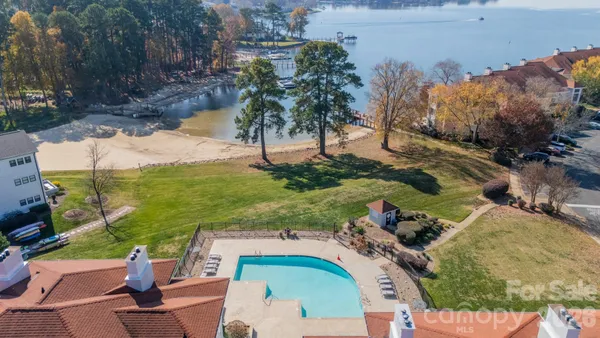 an aerial view of a house with a yard swimming pool and outdoor seating
