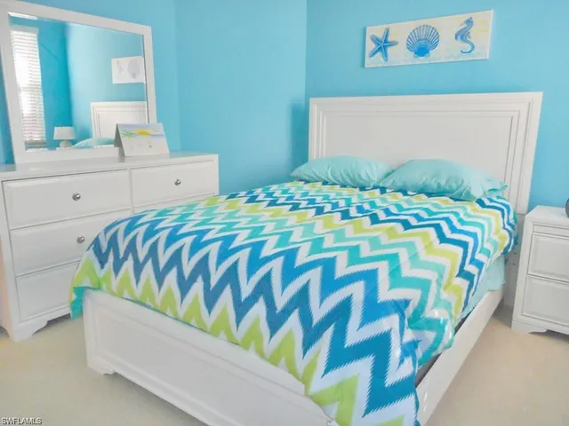 a bedroom with a bed and a desk