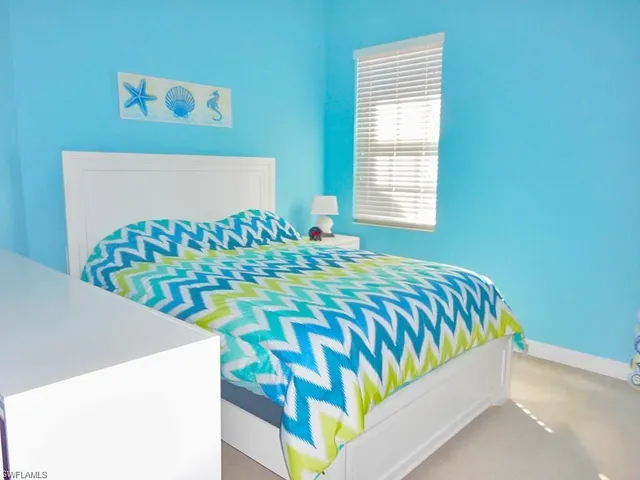 a bedroom with a bed and a table