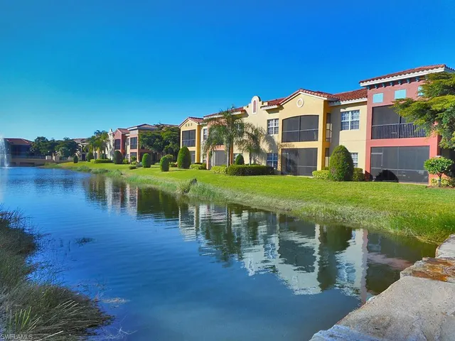 a view of a lake with a house in the background