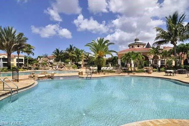 a view of a swimming pool and lounge chairs