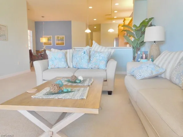 a living room with furniture and a lamp