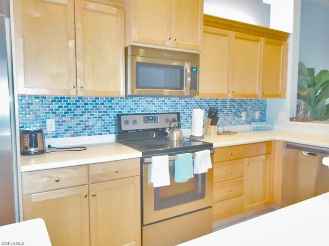 a kitchen with stainless steel appliances granite countertop a sink and cabinets