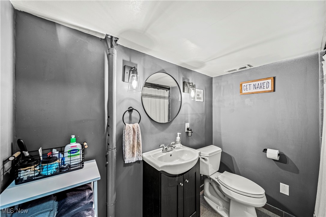 2959 Reeves Road Willoughby, OH 44094 - Photo 23 of 32 Bathroom with tile patterned floors, vanity, and toilet