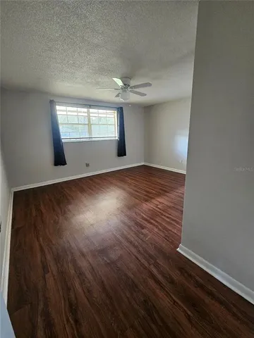 a view of a hallway with wooden floor and entryway