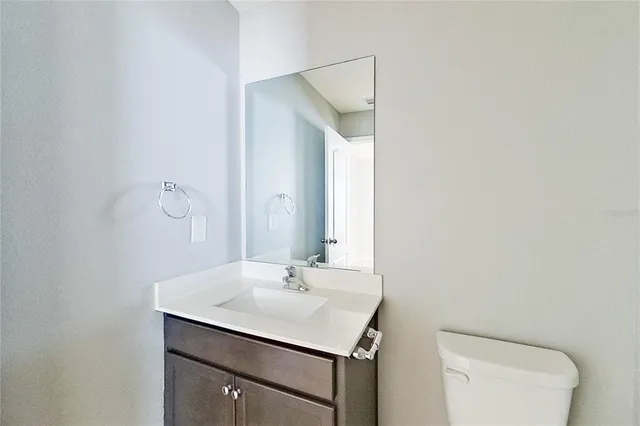 a bathroom with a sink toilet and mirror