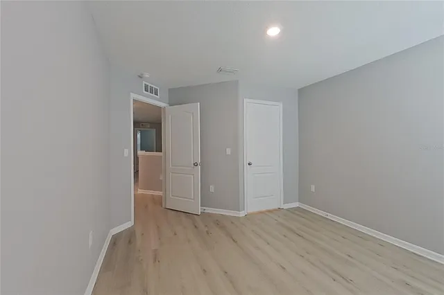 a view of hallway with wooden floor