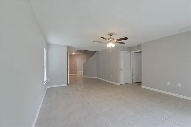 a view of an empty room with a ceiling fan