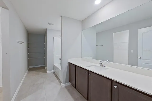 a bathroom with a double vanity sink mirror and shower