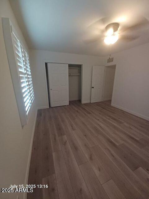 1312 West Roma Avenue Phoenix, AZ 85013 - Photo 13 of 17 an empty room with wooden floor and windows