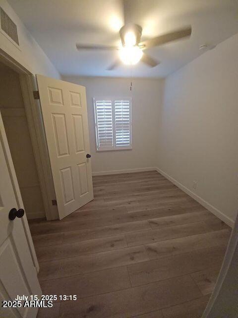 1312 West Roma Avenue Phoenix, AZ 85013 - Photo 15 of 17 wooden floor in an empty room with a window