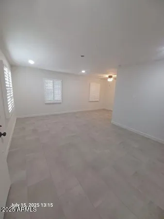 an empty room with windows and closet