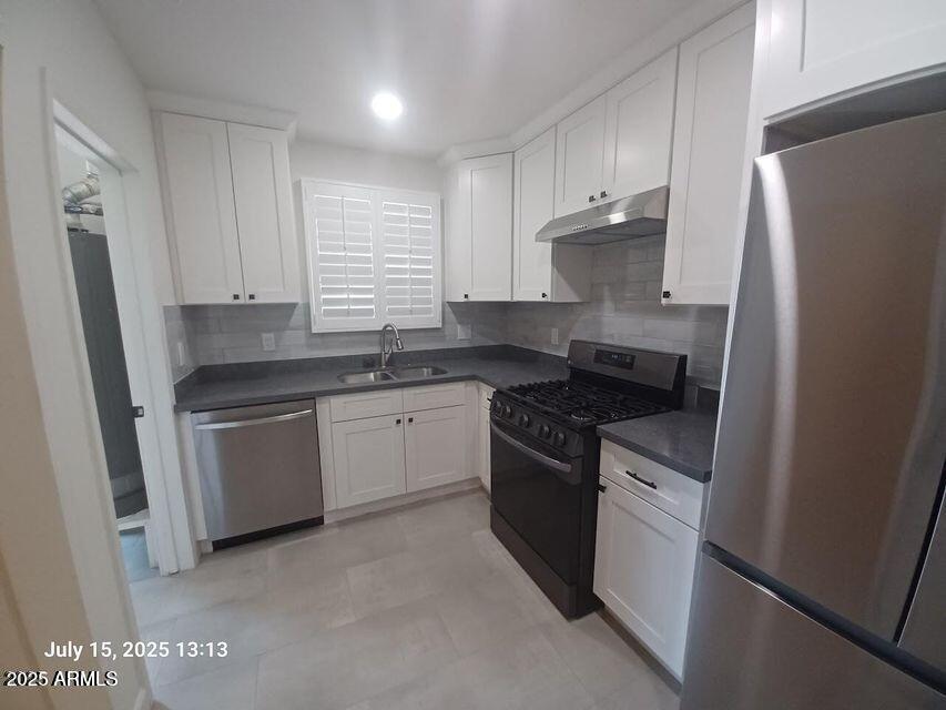 1312 West Roma Avenue Phoenix, AZ 85013 - Photo 6 of 17 a kitchen with stainless steel appliances granite countertop a sink stove refrigerator and cabinets