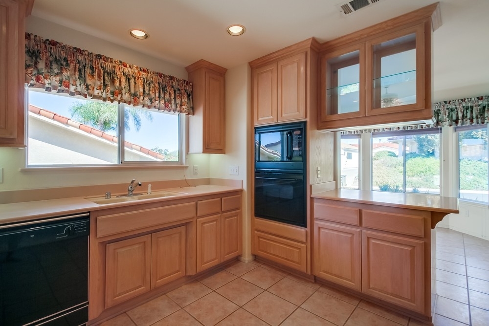 Solid surface counters, under-counter task lighting, built-in ovens, display cabinets and sunny breakfast nook with bay window.  Combined with abundant storage make this a dream kitchen and heart of the home.
