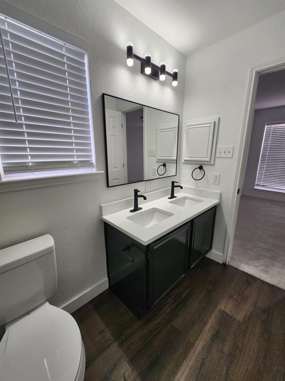 533 Bowie Street Forney, TX 75126 - Photo 3 of 7 a bathroom with a toilet sink and mirror