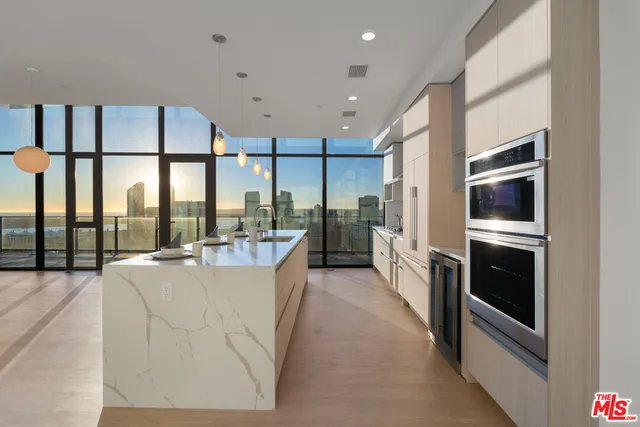 a large white kitchen with a large window