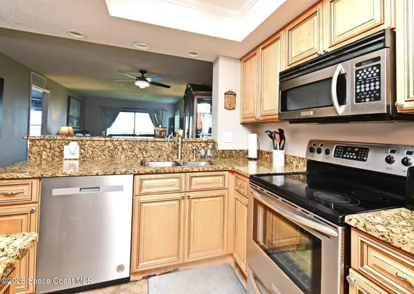 a view of washer and dryer with kitchen countertops